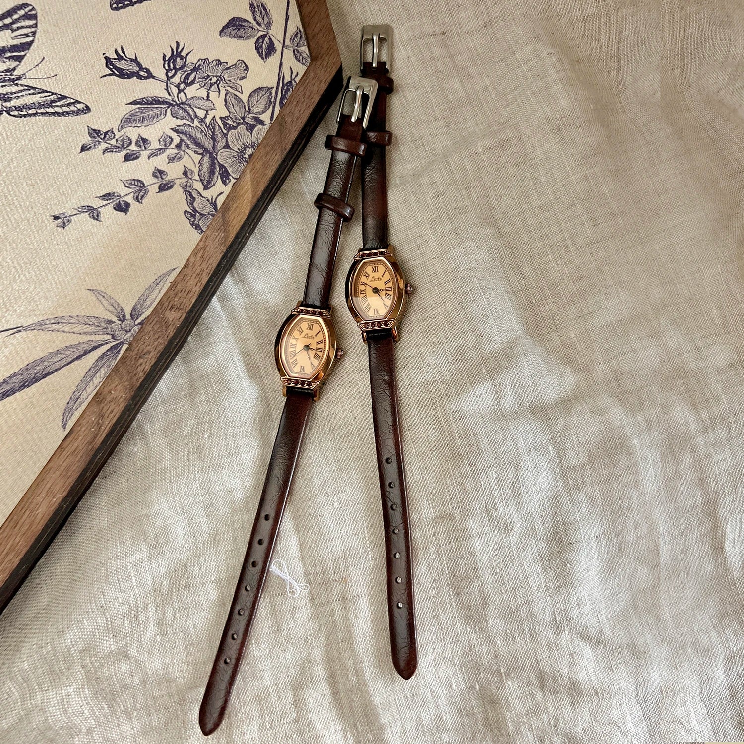 A classic watch with a brown leather strap and decorated with rhinestones.