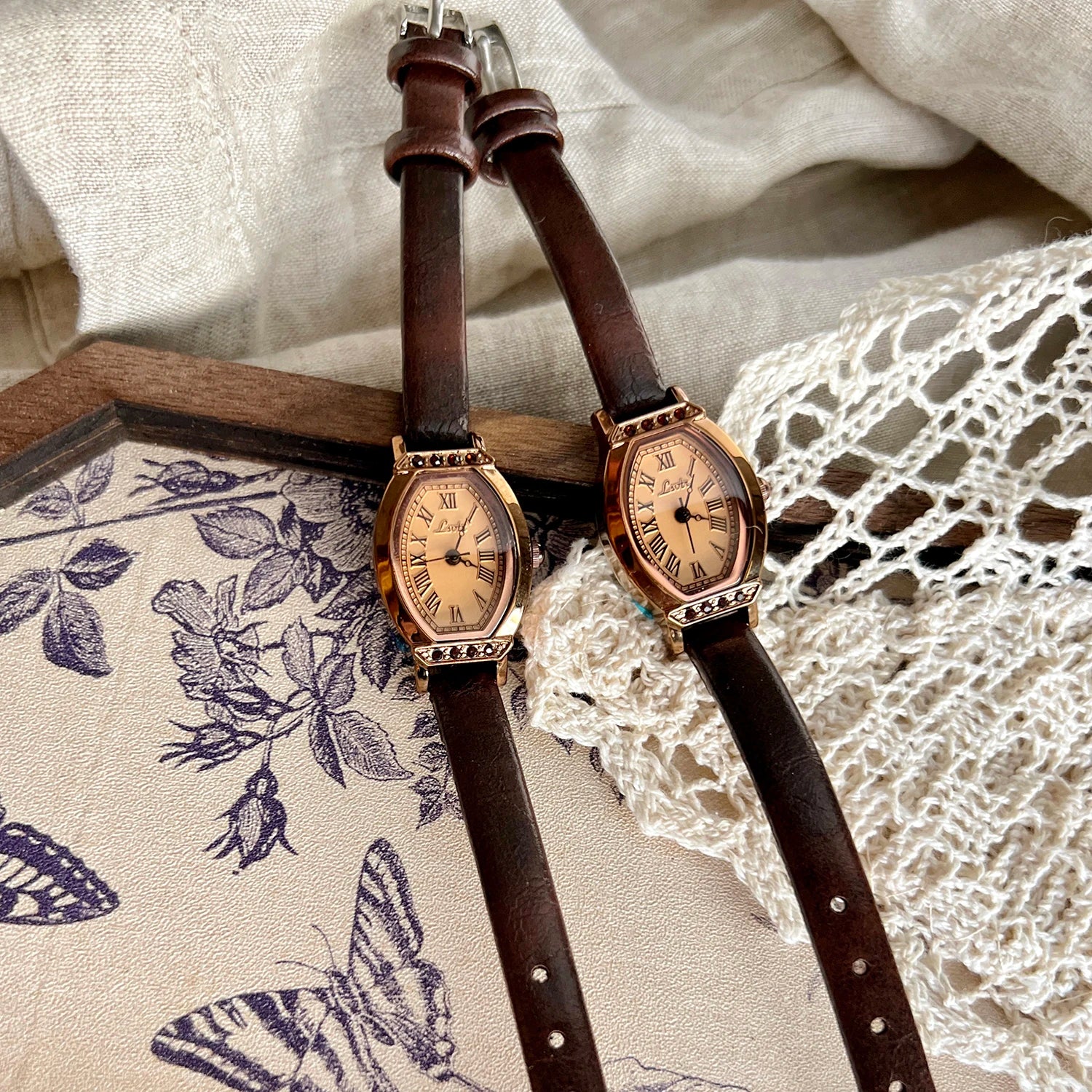 A classic watch with a brown leather strap and decorated with rhinestones.
